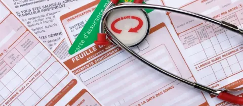 Un stéthoscope et des documents d'assurance maladie avec le concept de mutuelle santé.
