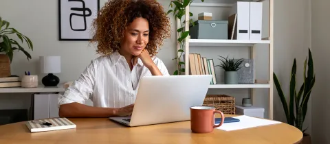 Femme qui travaille dans un bureau avec un ordinateur portable.