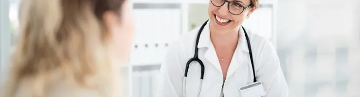 Médecin souriant face à son patient