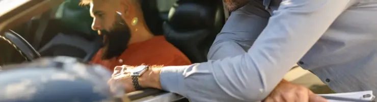 Un commercial montre les fonctionnalités d'un véhicule à un potentiel acheteur.