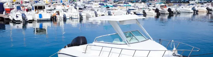 Bateaux amarrés dans une marina sous un ciel ensoleillé.