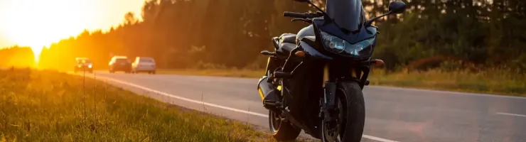 Moto sur la route au coucher du soleil.