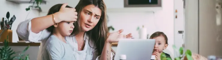 Mère en téléconsultation sur son ordinateur portable avec son enfant malade.