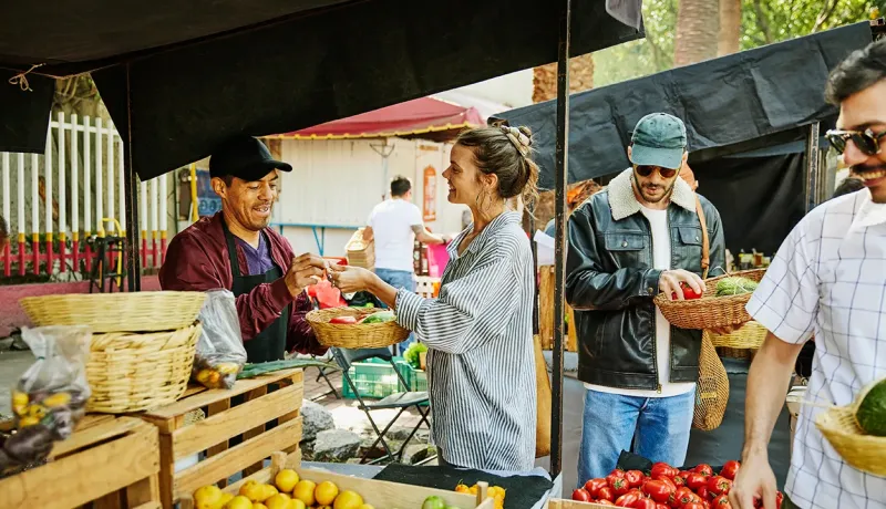 Personnes achetant des légumes sur un marché.